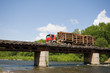Photo: Truck loaded with logs going over the bridge. Truck loaded with logs going over the bridge.