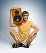 Cool dude in color striped trousers with wooden speaker Cool dude in color striped trousers with wooden speaker