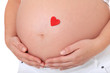 Schwangere Frau mit rotem Herz auf Babybauch Schwangere Frau mit rotem Herz auf Babybauch