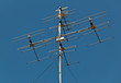 television antennas on blue sky