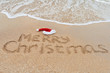 Merry Christmas written on tropical beach sand