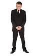 standing serious businessman in black suit, full length