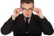 serious businessman in black suit correcting glasses