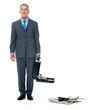 Businessman holding open suitcase with papers falling down