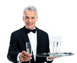 Waiter welcoming you with a drink