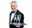 Smiling waiter greeting guests with drinks