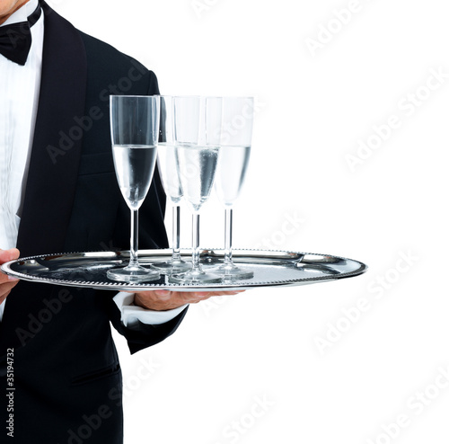 Photo: Waiter serving champagne isolated on white Waiter serving champagne isolated on white