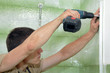 Plumber using screwdriver or drill Plumber using screwdriver or drill