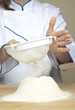 Photo: Flour sifting (shot of flour falling through the sieve) Flour sifting (shot of flour falling through the sieve)