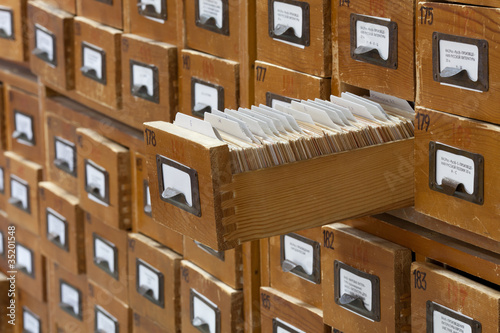 Photo: database concept. vintage cabinet. library card or file catalog. database concept. vintage cabinet. library card or file catalog.