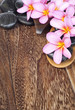 Photo: Tropical spa concept with Plumeria flower and pabble stone Tropical spa concept with Plumeria flower and pabble stone