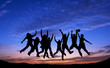 Crowd of friends jumping on blue sky background Crowd of friends jumping on blue sky background
