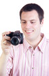 Young man with digital camera, smiling