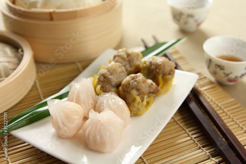 Photo: Dimsum by tea cups and bamboo steamer Dimsum by tea cups and bamboo steamer