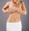 Woman examining her breast