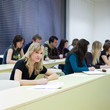 pretty female college student sitting in a classroom