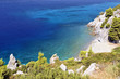 Clear sea water with stones and green tropical coastline Clear sea water with stones and green tropical coastline