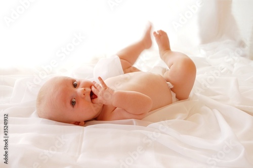 Photo: Cute Baby on a white blanket Cute Baby on a white blanket