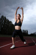 Athlete woman lunge stretch on athletics track