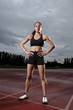 Young female athlete on athletics running track