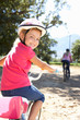 Little girl on country bike ride with mom