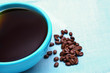 Photo: closeup of a blue coffee mug and beans closeup of a blue coffee mug and beans