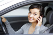 happy young woman talk on cell phone sitting in white car