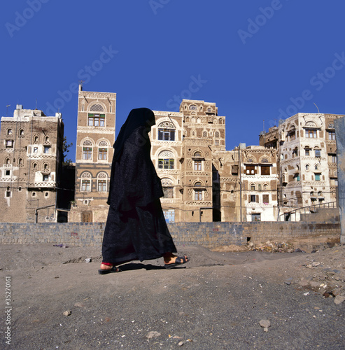 Photo: A veiled Muslim woman walks on a Sana a street, Yemen A veiled Muslim woman walks on a Sana a street, Yemen
