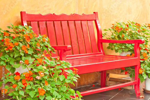 Photo: red color armchair in the garden red color armchair in the garden