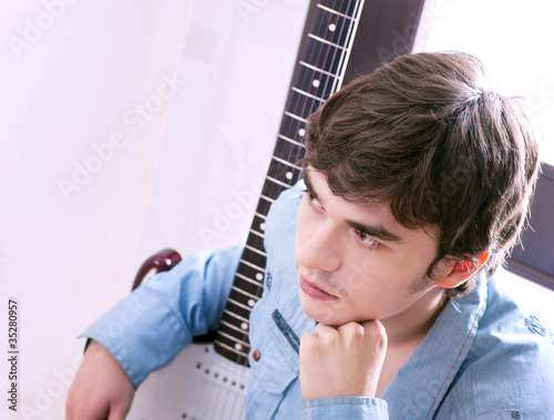 Photo: young handsome guy with a guitar young handsome guy with a guitar