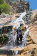 Men descending waterfall