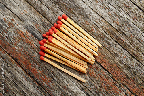 Photo: Group of matches on wooden texture Group of matches on wooden texture
