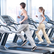 Young woman and man at the gym exercising. Running
