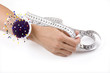 Hand with pincushion and measuring tape
