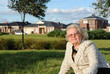 Healthy senior lady sitting on grass