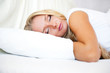 Portrait of young beautiful sleeping woman on bed at bedroom