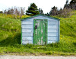 Closeup of an old green-doored fishing shed