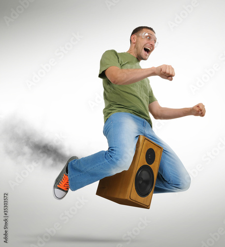 Photo: Unreal flying man on a speaker and smoke Unreal flying man on a speaker and smoke