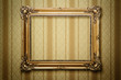 Grunge gold wooden frame on striped wallpaper with clipping path Grunge gold wooden frame on striped wallpaper with clipping path