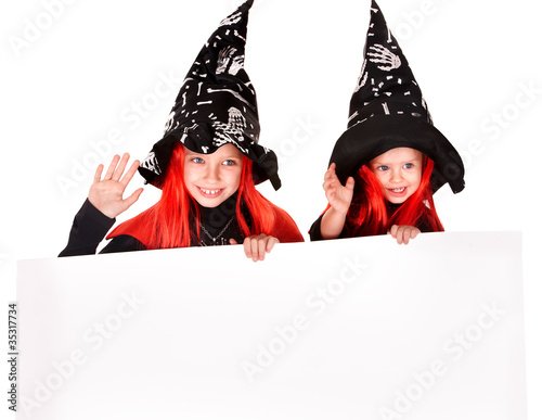 Photo: Child witch holding banner . Child witch holding banner .
