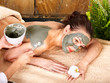 Young woman having clay body mask. Young woman having clay body mask.