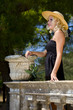 Photo: Closeup portrait of pretty blond woman wearing a nice summer hat Closeup portrait of pretty blond woman wearing a nice summer hat