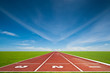Running track with three lanes over sky and clouds