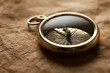 Old compass isolated on vintage paper background Old compass isolated on vintage paper background