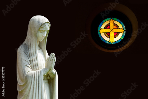 Photo: Isolated statue of Mary with cross Isolated statue of Mary with cross
