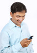 Photo: Indian Young Businessman Using a Cell Phone Indian Young Businessman Using a Cell Phone