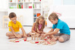 Three kids playing with wooden blocks Three kids playing with wooden blocks