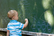 Photo: Boy drawing with chalk Boy drawing with chalk