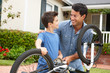 Father and son fixing bike