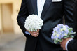 Groom and a bestman holding flowers during the wedding ceremony Groom and a bestman holding flowers during the wedding ceremony